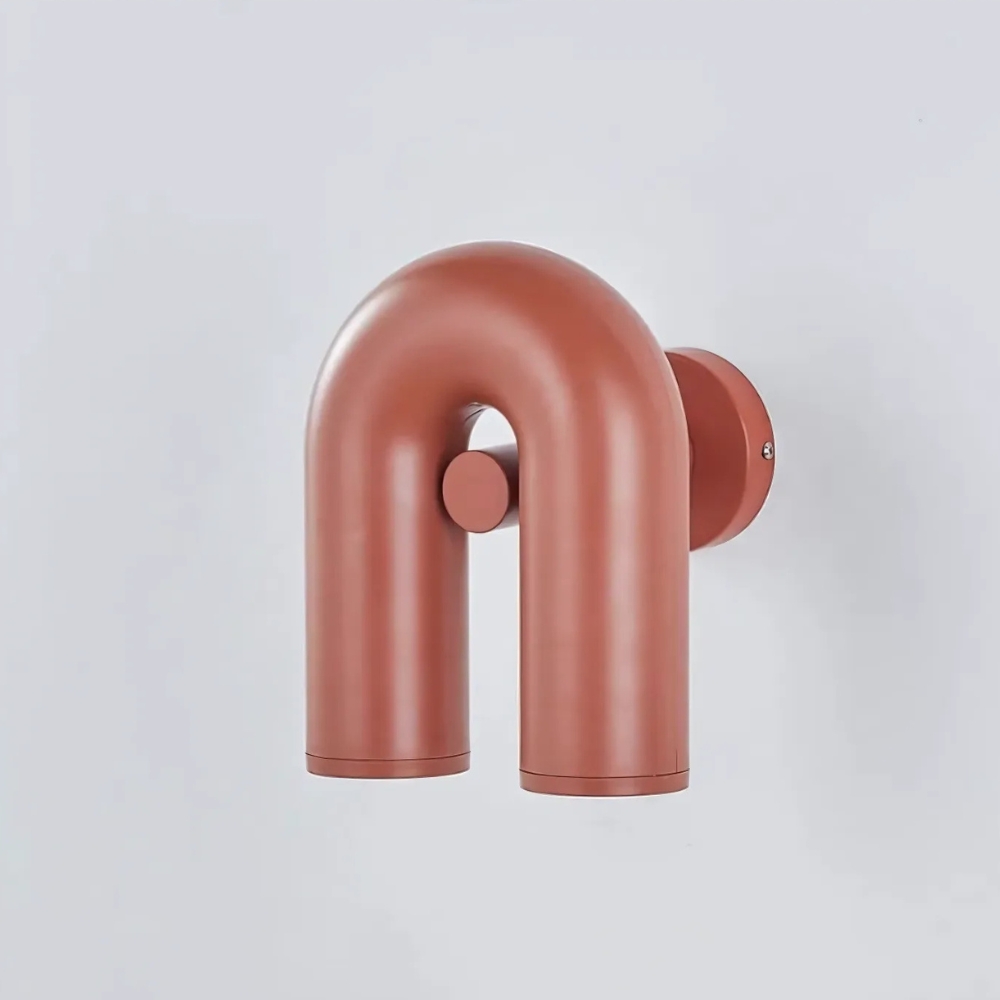 Terracotta U-shaped tubular wall light on a plain white background