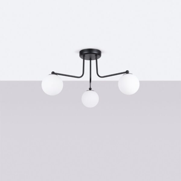 Black three-arm ceiling light holding round white glass globes