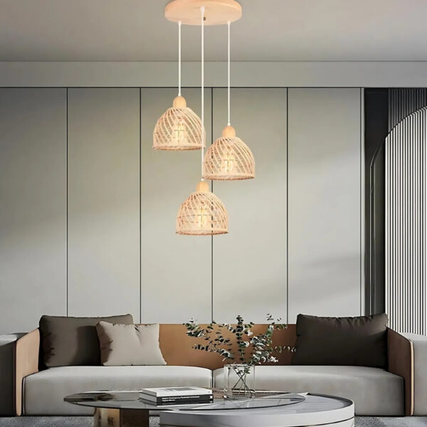 Cluster of three woven dome pendant lights hanging over a sofa