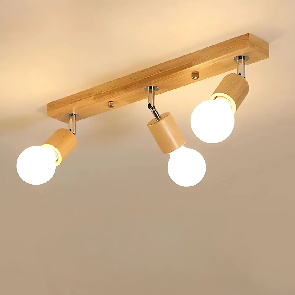 Wooden ceiling spotlight bar with three adjustable heads and lit bulbs