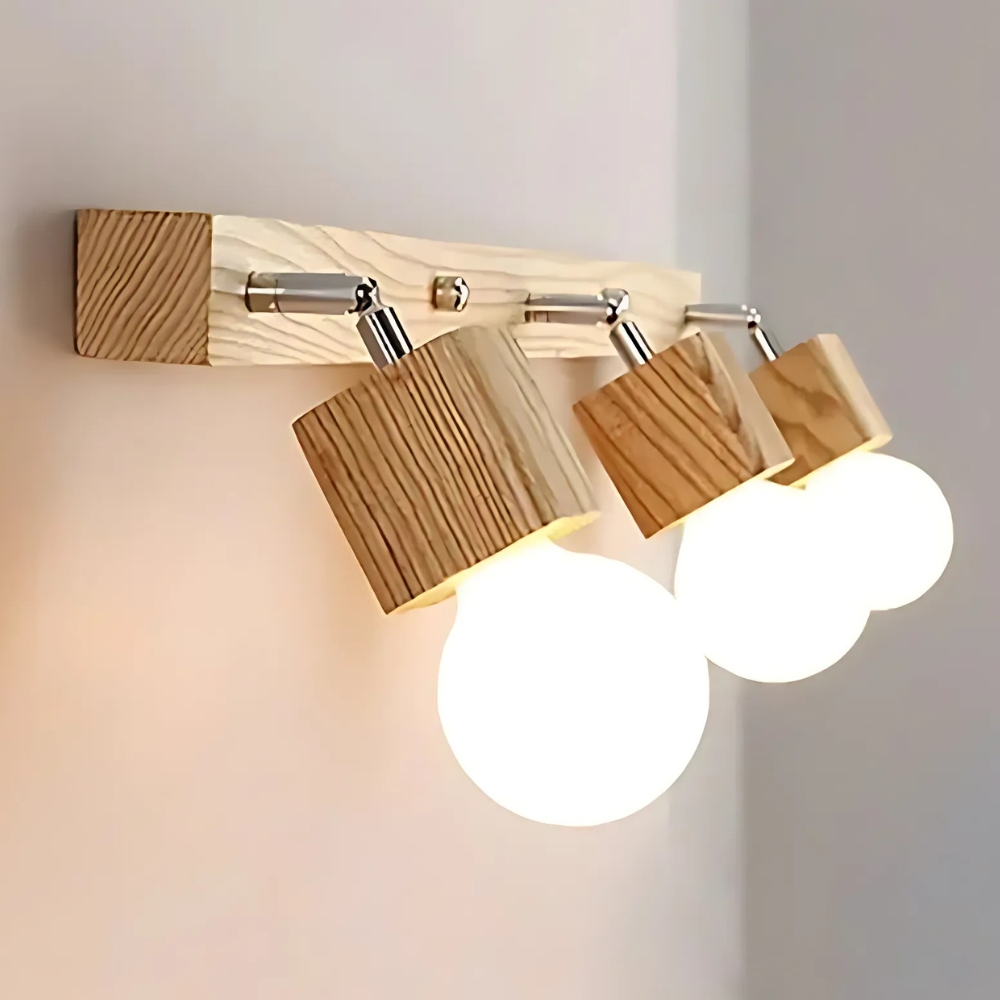 Wooden wall light with three adjustable cylinder heads and lit bulbs