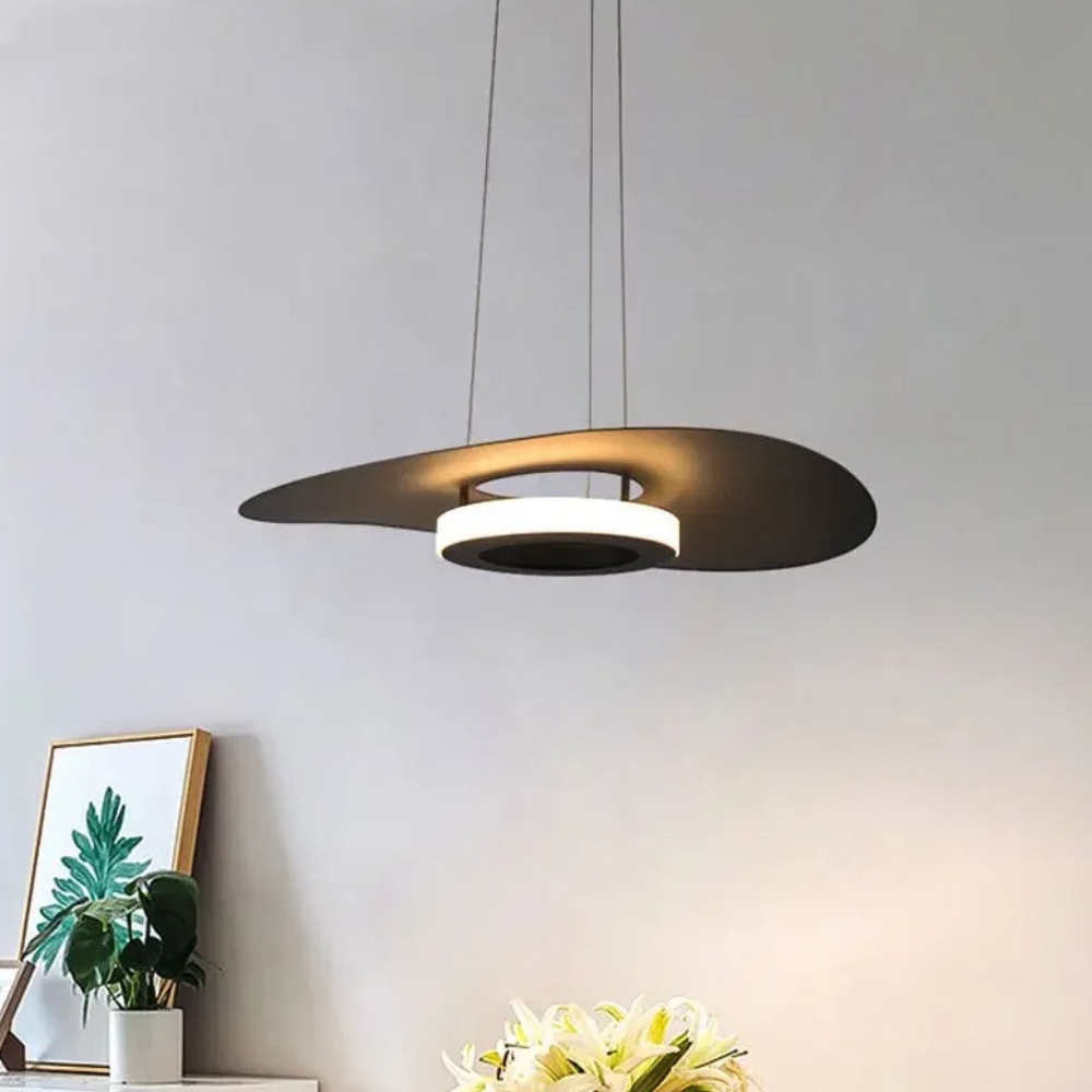 Sculptural bronze pendant light shaped like a swirling wing