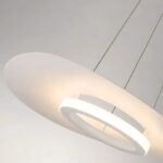 Angled close-up of the flat disc pendant showing its glowing white ring