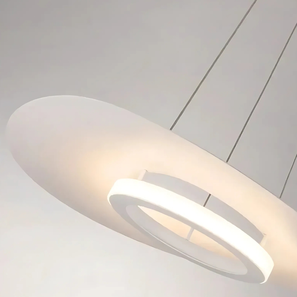 Angled close-up of the flat disc pendant showing its glowing white ring