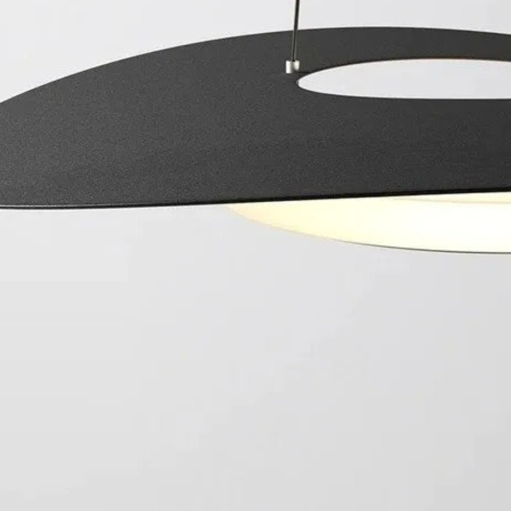 Close-up of the disc pendant's edge with a bright ring shining underneath