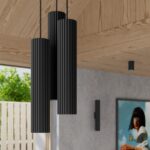 Black fluted cylinder pendants hanging on a covered outdoor patio