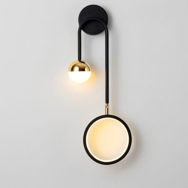 Black wall light with a curved arm, a small brass ball light and a ring shaped light below