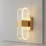 Gold wall light with an illuminated infinity loop wire design