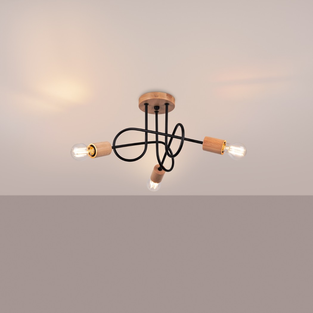 Black wire ceiling light with three wood bulb holders and warm glowing bulbs