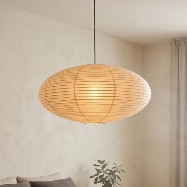 Oval rice paper pendant light glowing above a sofa