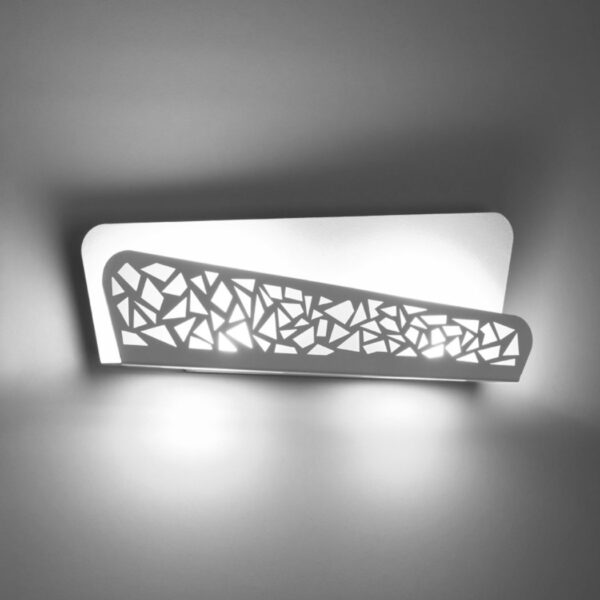 White wall light with an angular openwork panel casting shadows