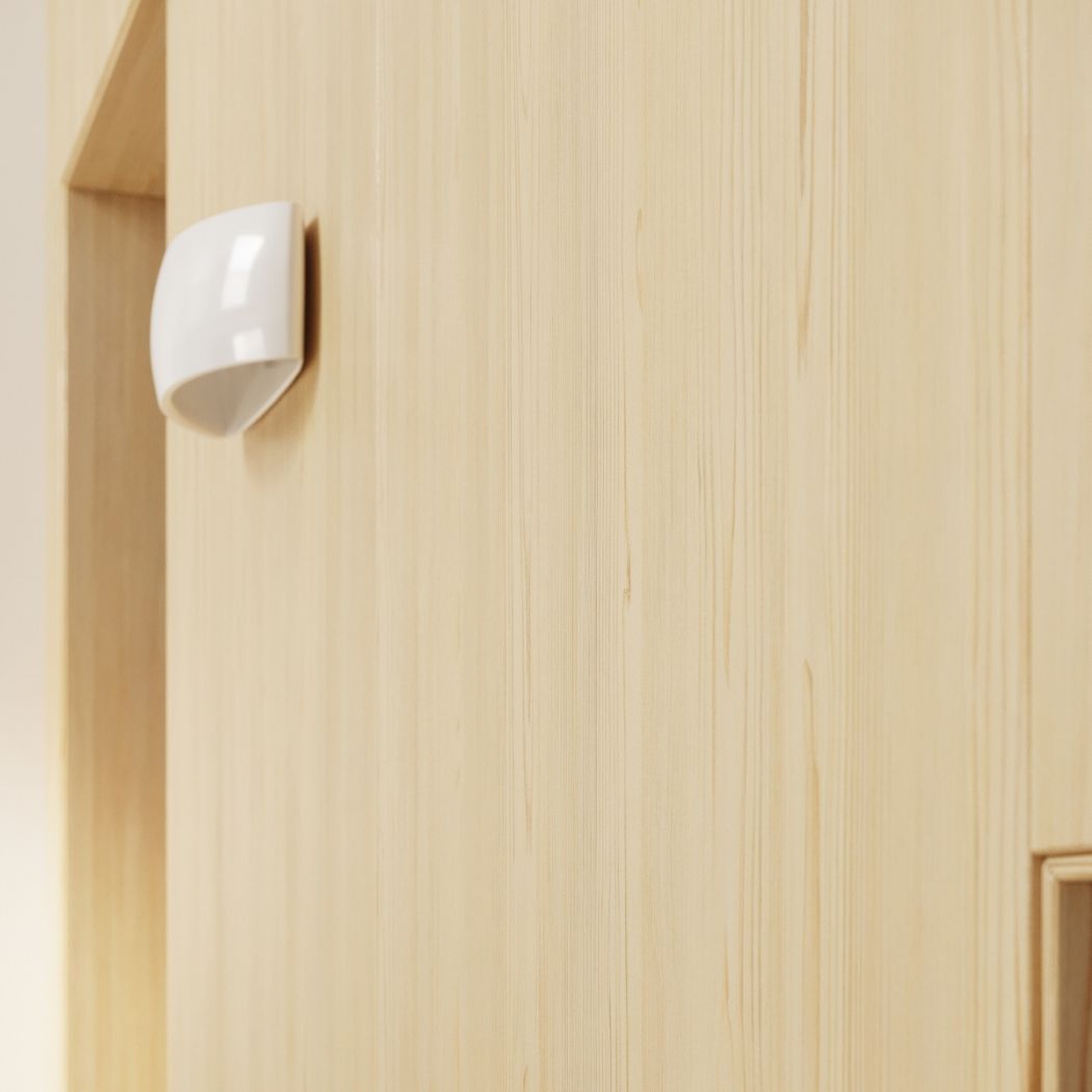 Small glossy white half moon wall light mounted on a light wood panelled surface
