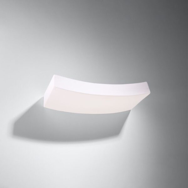 Curved elongated white ceramic wall light with a glowing underside