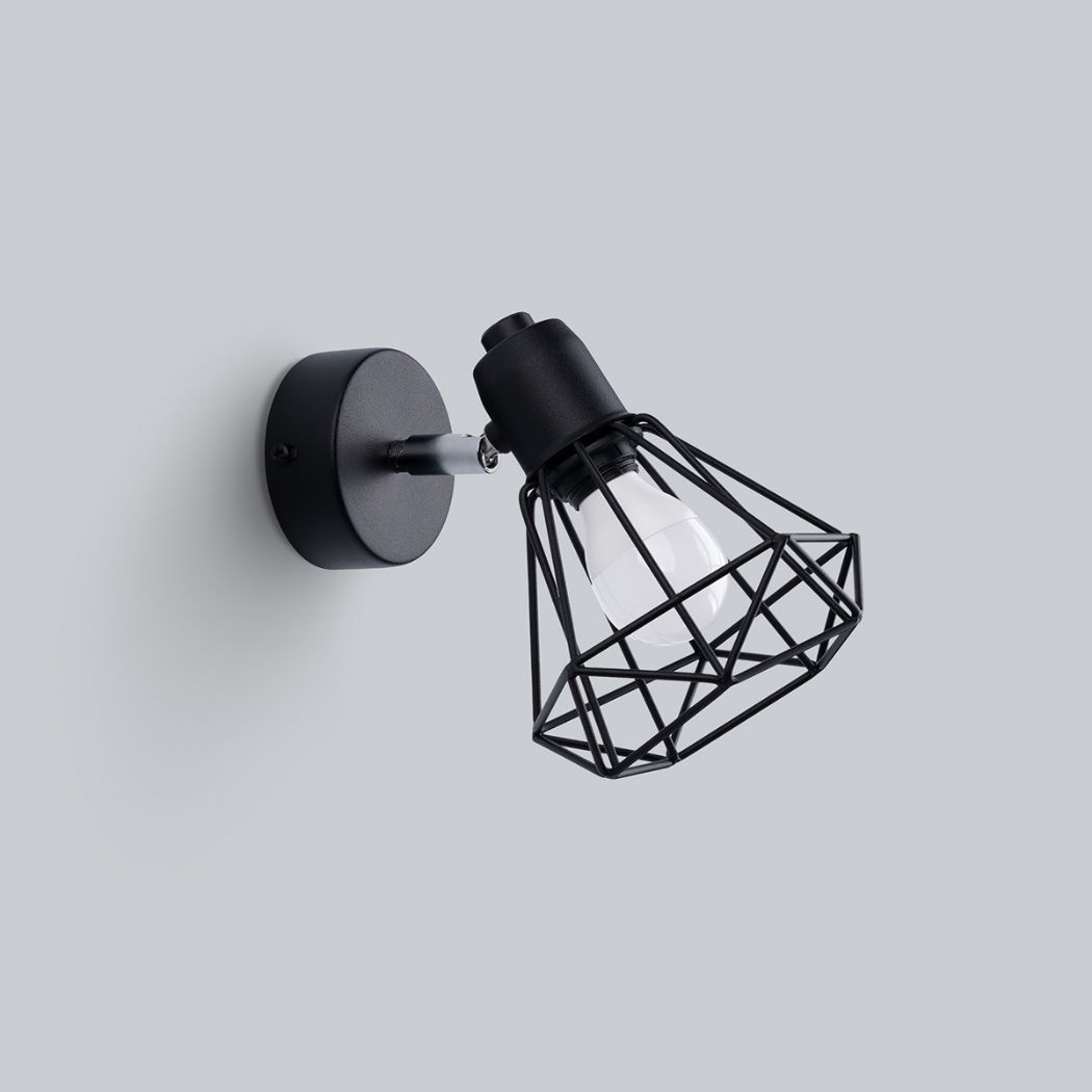 Black wire cage wall spotlight with an exposed bulb on an adjustable arm