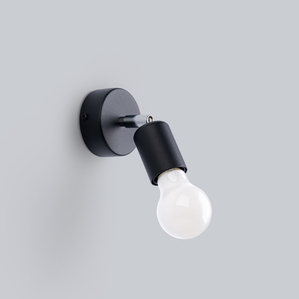 Black wall spotlight with an angled head and exposed bulb