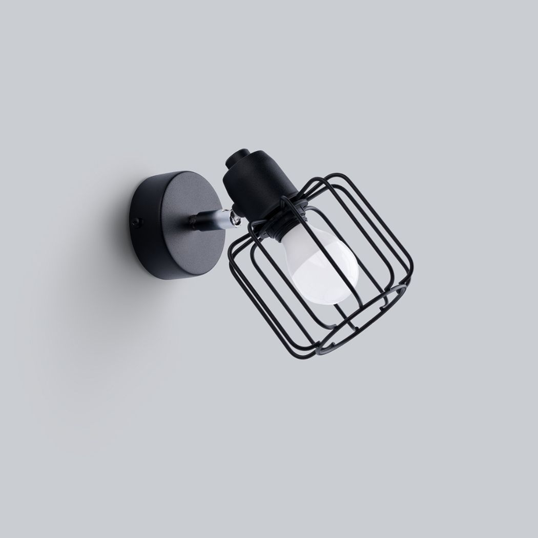 Black wire cage wall spotlight with a visible round bulb