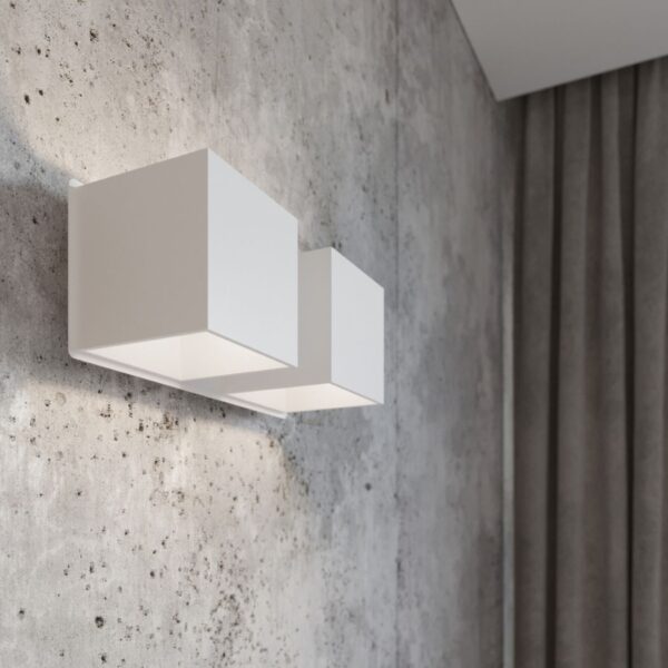 White stepped double cube wall light mounted on a concrete wall
