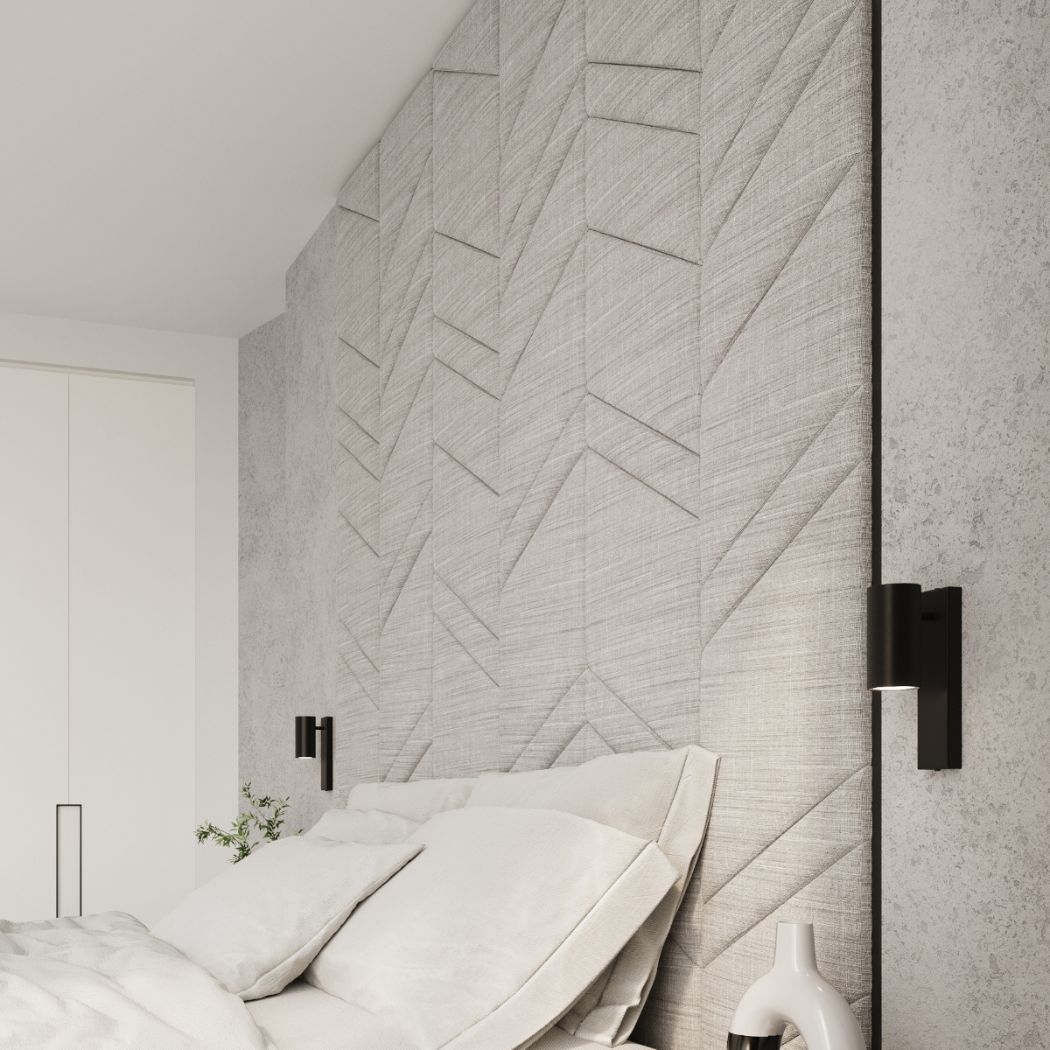 Bedroom corner with black wall lights beside a headboard panel and dark door frame