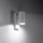 White rectangular wall bracket with a cylindrical shade casting light downward