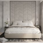 Bedroom with a chevron-patterned headboard wall and two white wall lights