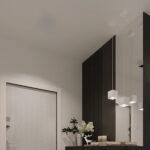 Three white cube pendants at staggered heights above an entryway console with a deer figurine