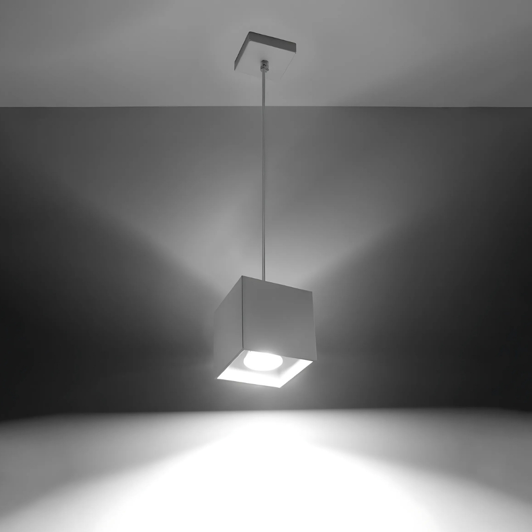 Grey cube pendant on a bent ceiling bracket glowing brightly against a plain background