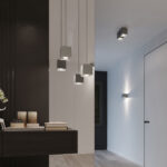 Cluster of grey cube pendants at staggered heights beside a console table and candles