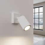 White ribbed cylindrical spotlight wall light aimed downward