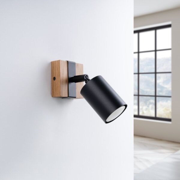 Black spotlight wall light mounted on a wood and black square base