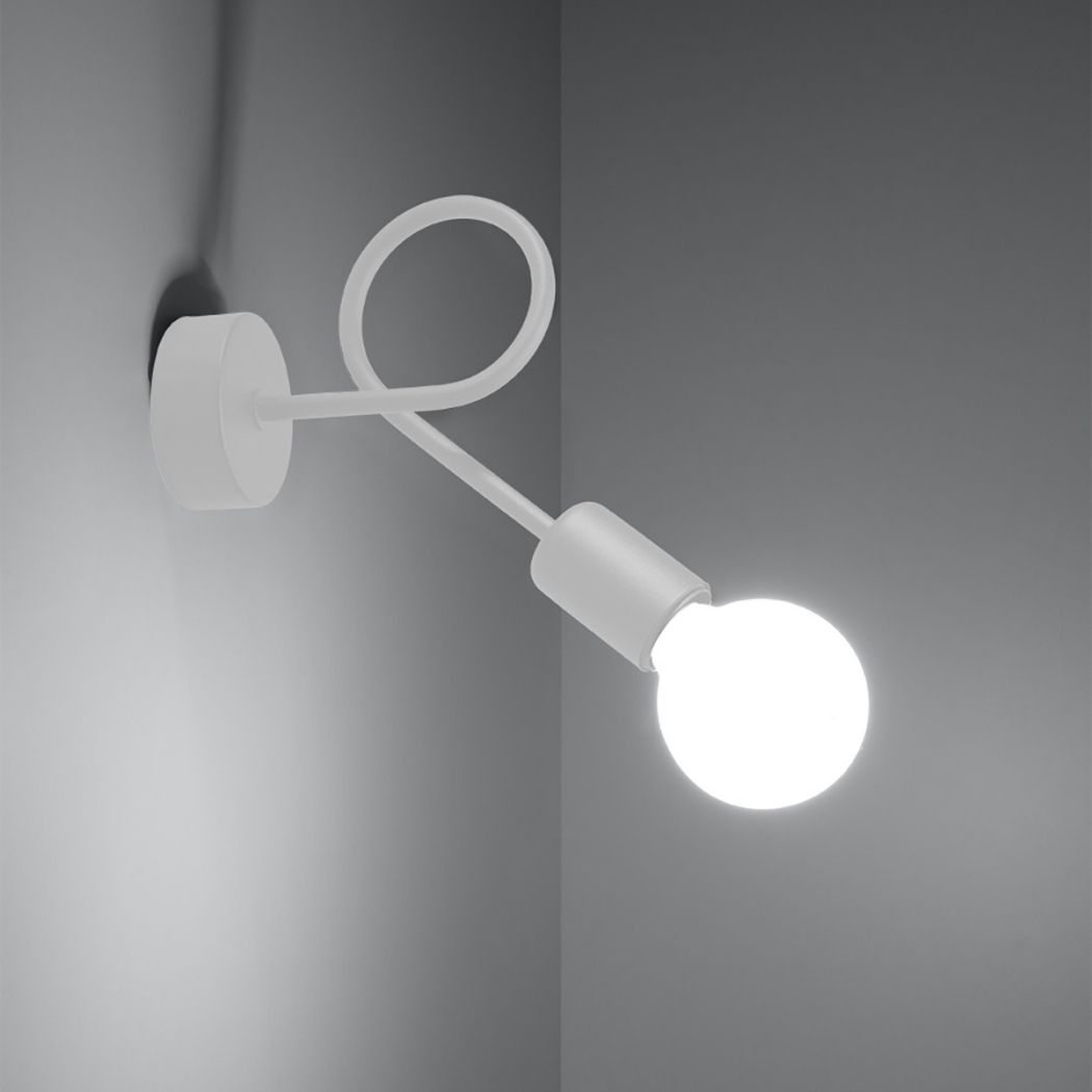 White spider style wall light with a looping frame and a lit round bulb in the corner of a room