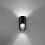 Black angled cylinder wall light casting light upward and downward