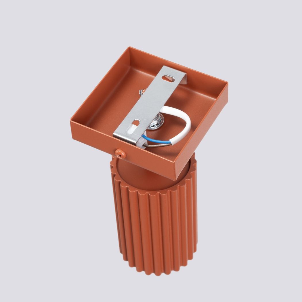 Close-up of the terracotta spotlight head and its square mounting bracket