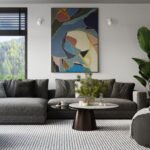 Living room with two small round wall lights flanking an abstract painting above the sofa