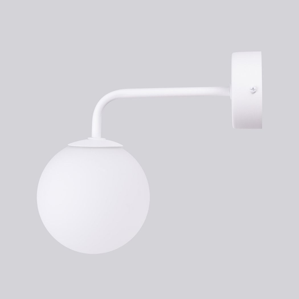 White glass globe wall light with a curved arm, side view, switched off