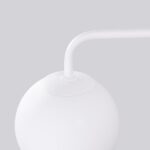 Close-up of the joint between the curved arm and the white glass globe