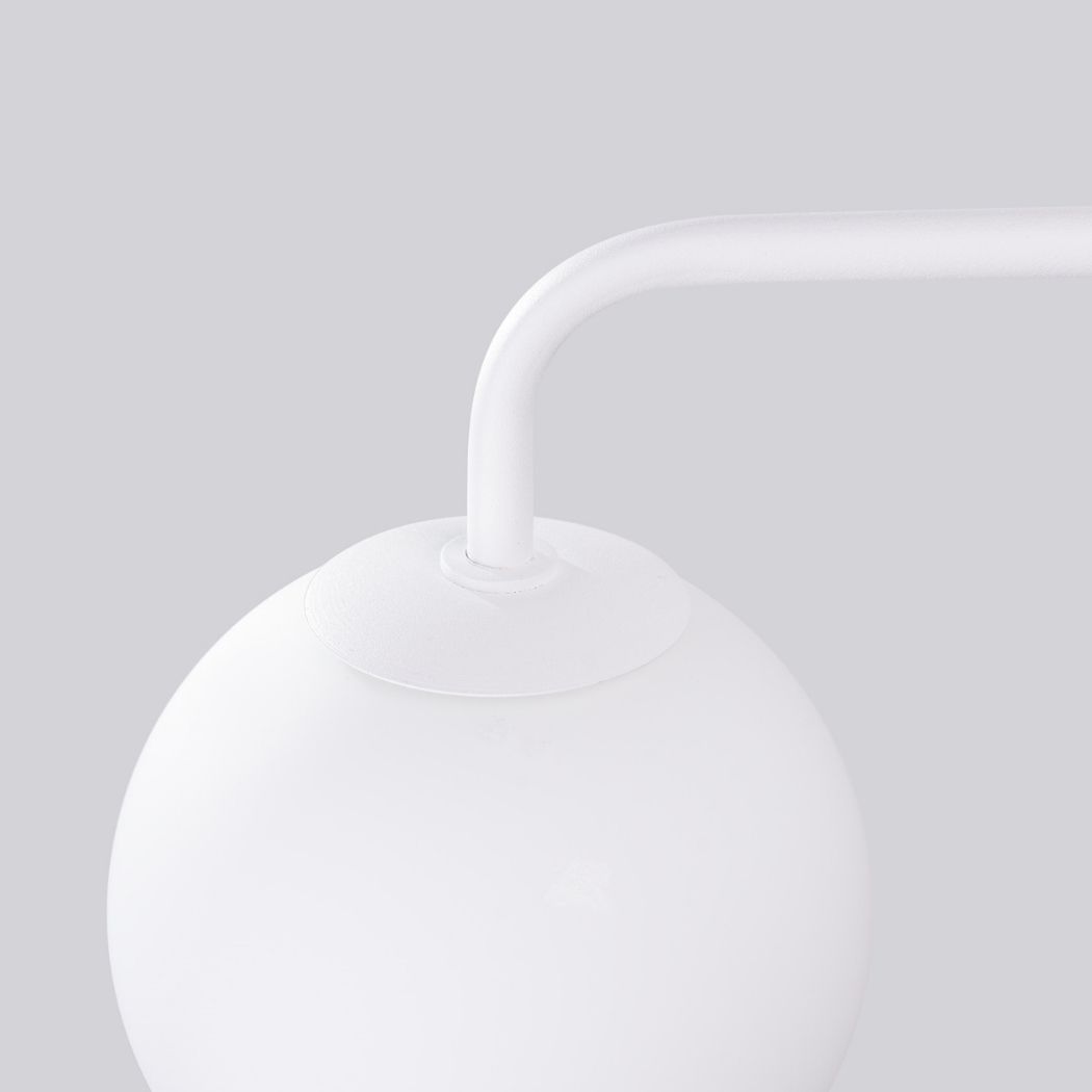 Close-up of the joint between the curved arm and the white glass globe