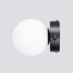 Side view of the black round glass ball wall light with its toggle switch