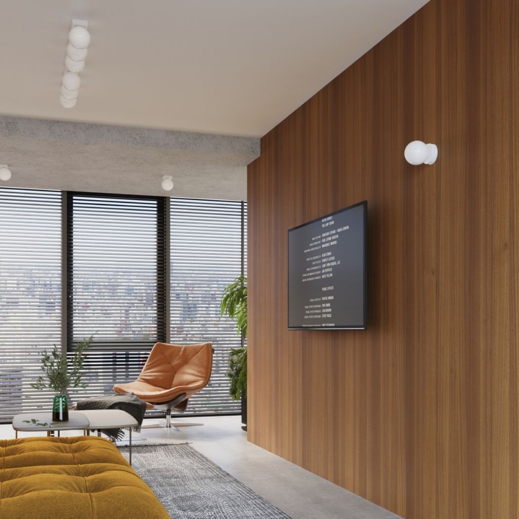 Small round glass ball wall lights on a wood slat wall in a lounge with an armchair