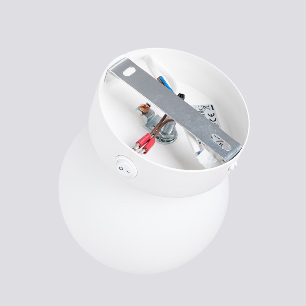 Open interior view of the round glass ball wall light showing its switch and wiring