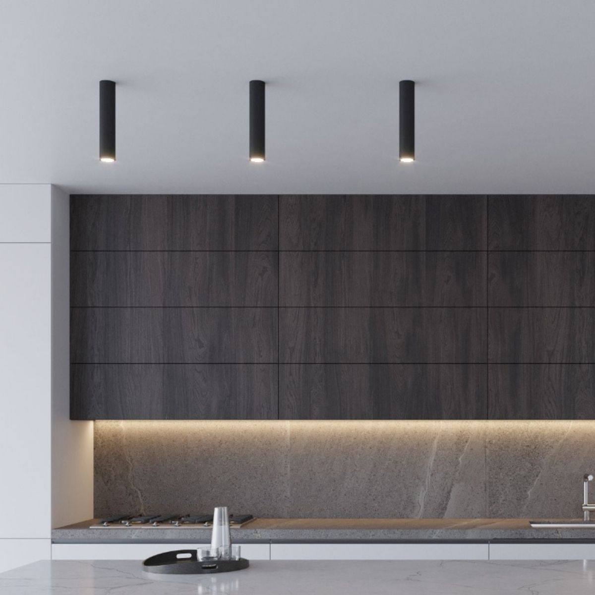 Three black cylindrical ceiling spotlights above a dark wood kitchen cabinet
