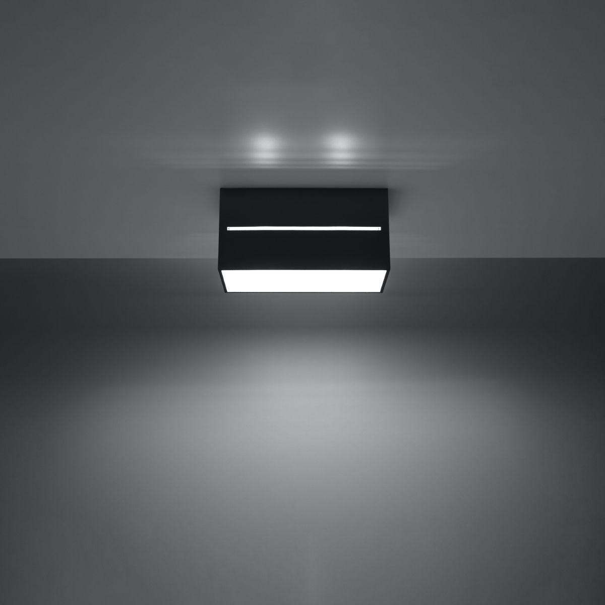 Black rectangular ceiling light lit with a bright glowing strip