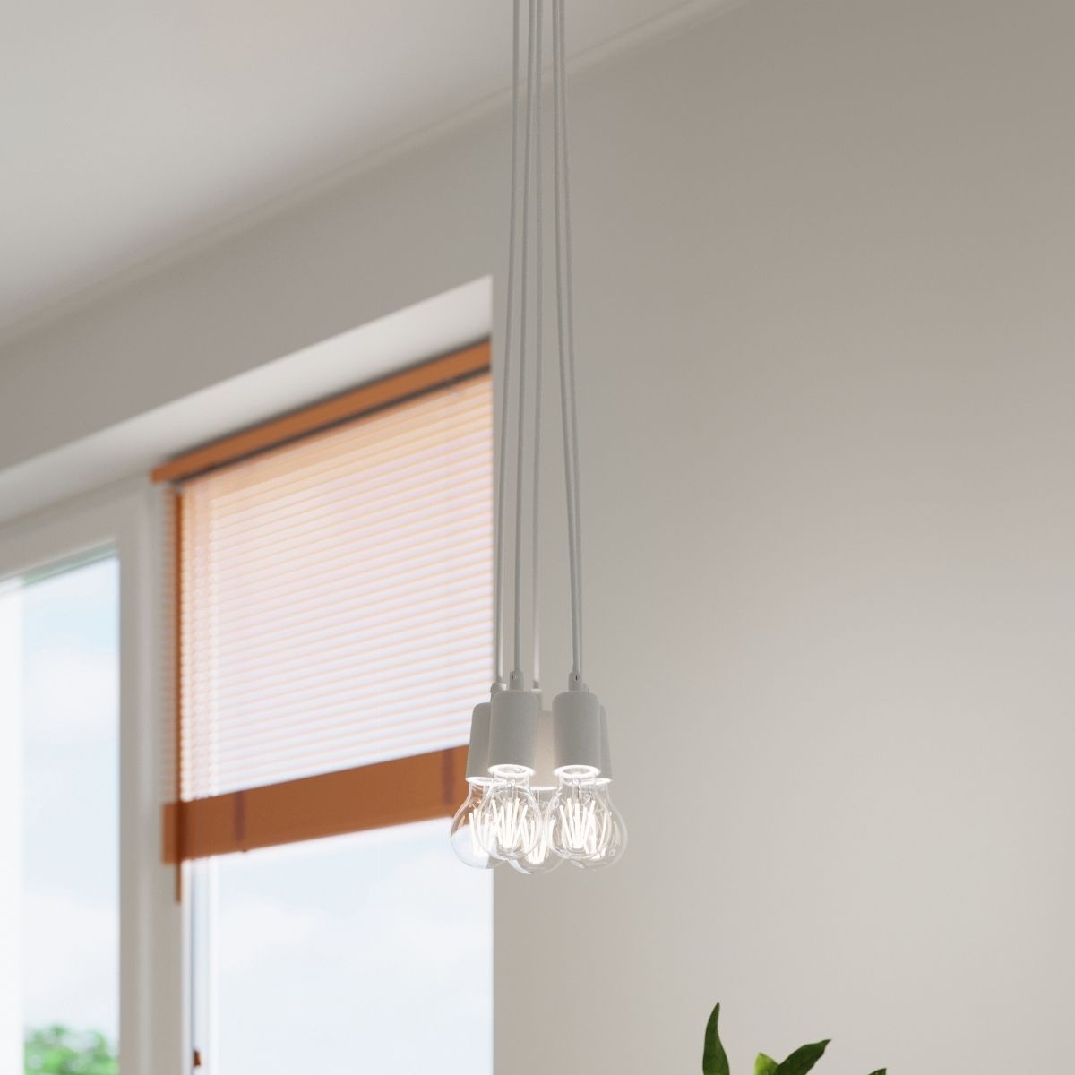 Cluster of round wire cage pendant lights with exposed bulbs