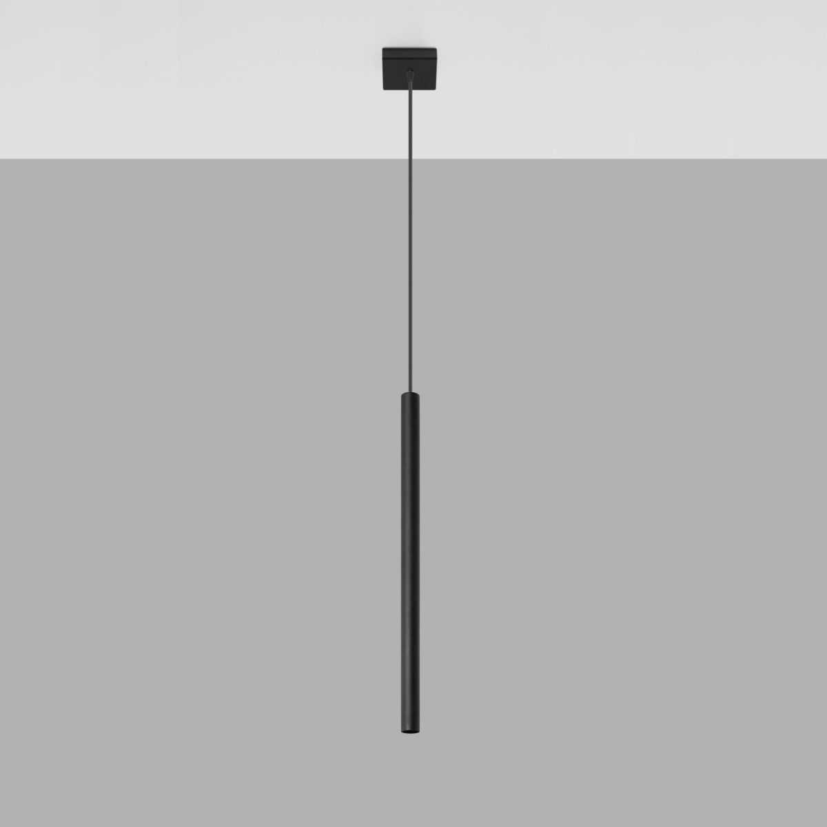 Slim black cylindrical pendant light hanging from a thin cable on a plain background