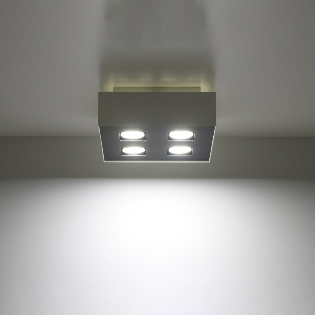 Square ceiling light fixture with four bright spotlight bulbs mounted on the ceiling
