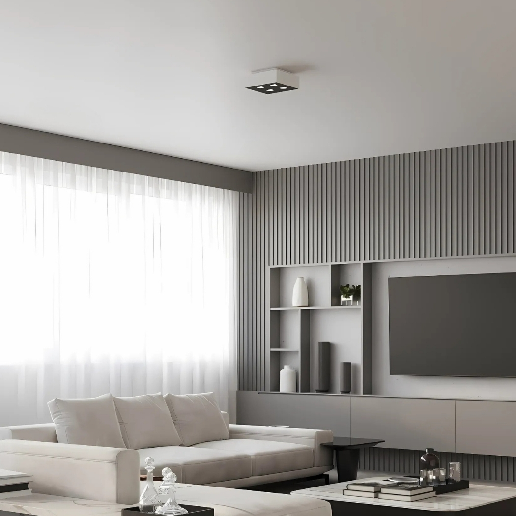 Small white square ceiling light glowing above a grey panelled wall