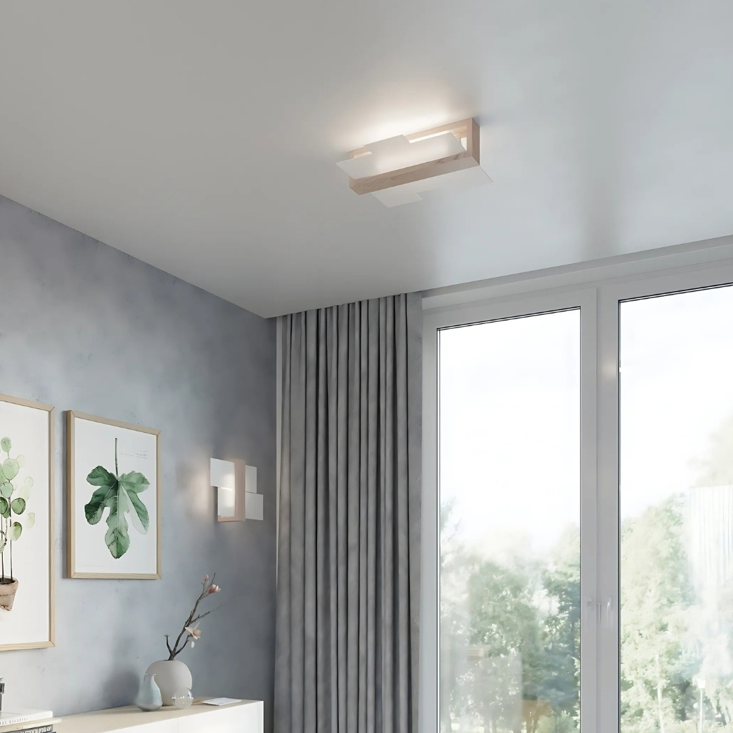 Angular wood and white ceiling light in the corner of a room with grey curtains and a window