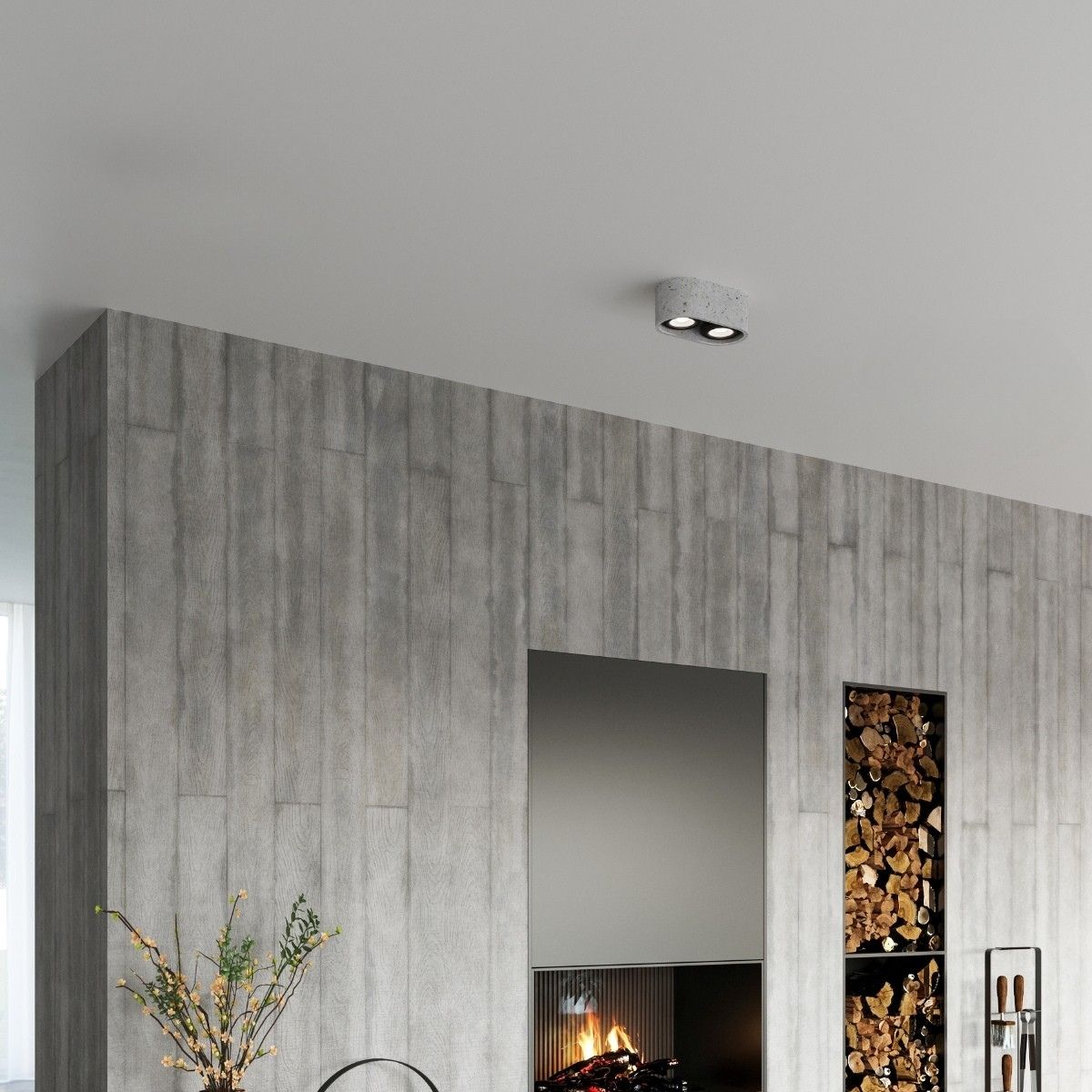 Small gray two spot ceiling light near a concrete wall and a fireplace