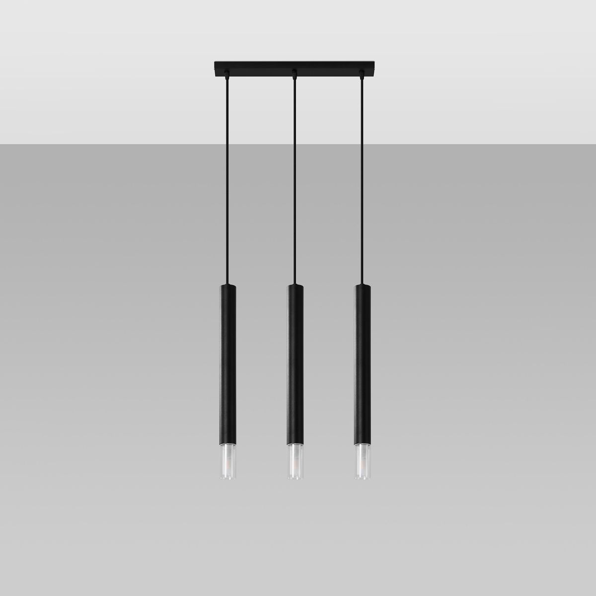 Three slender black cylindrical pendant lights hanging from a black bar