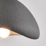 Close-up of the rough stone like texture on the edge of the dome pendant shade