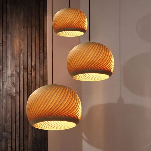 Cluster of three ribbed wooden dome pendant lights glowing warmly